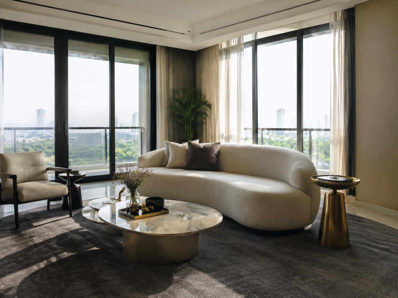 Contemporary living room with curved sofa and brass tables