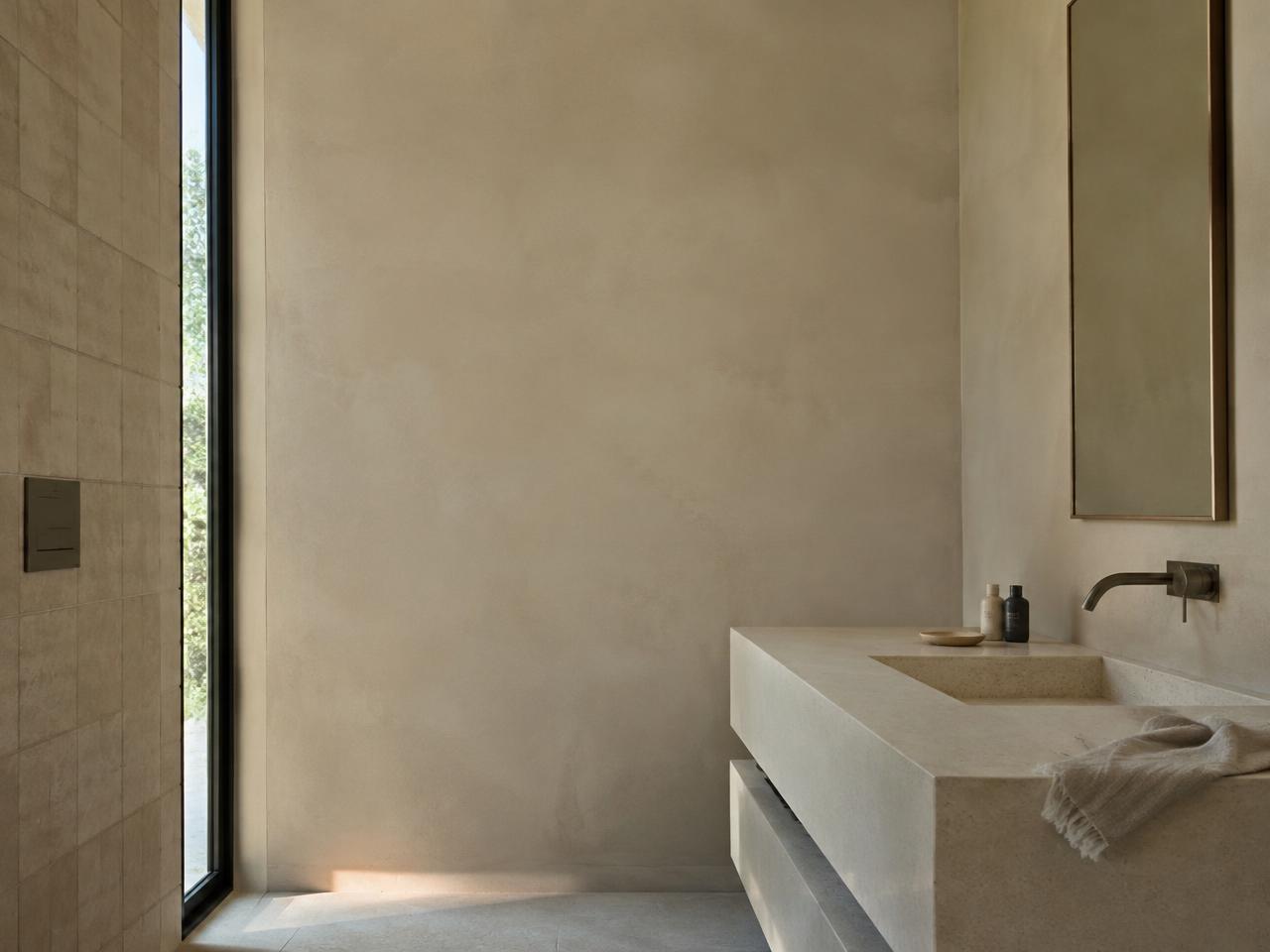 Minimalist bathroom in microcement and pale stone